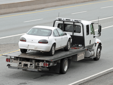 Flatbed Towing Company giving Towing Services